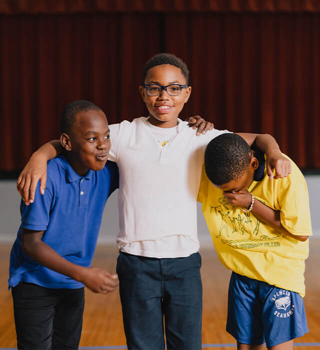 Three boys laughing together