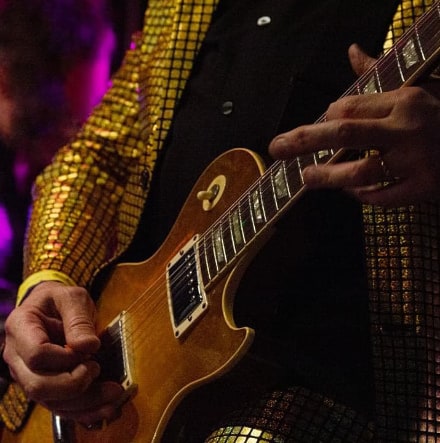 hands playing a guitar