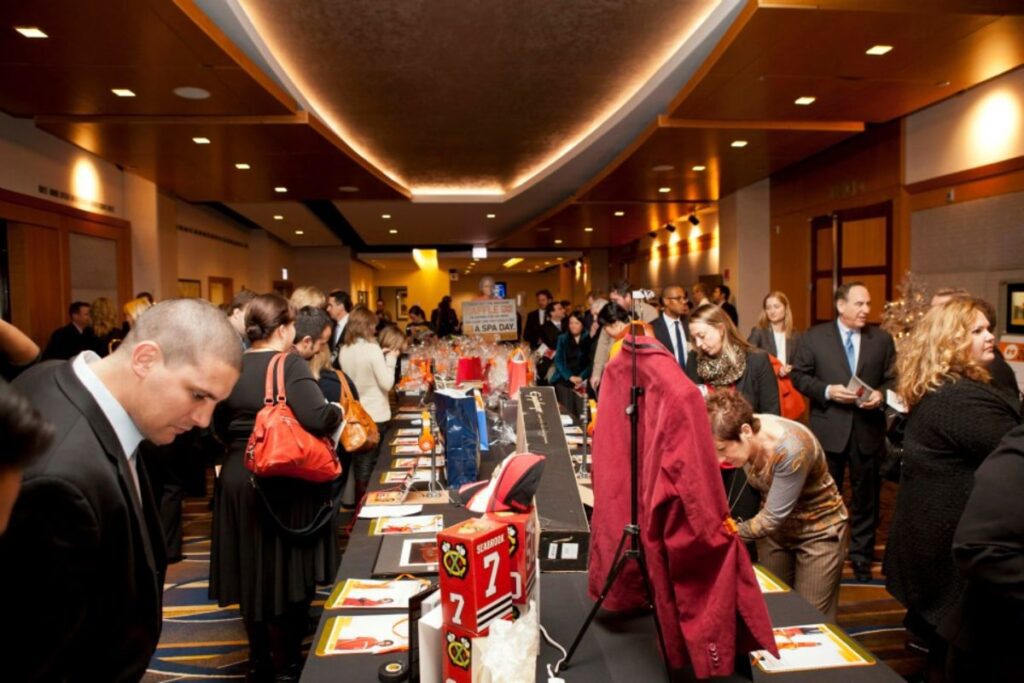 people browsing holiday luncheon silent auction tables