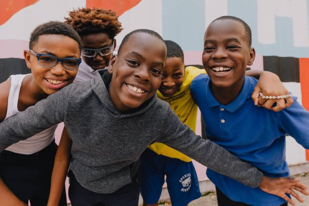 kids joyfully playing outside and posing for camera